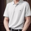 Young man in a white polo shirt standing with both hands placed over his crotch, looking forward calmly （白いポロシャツを着た若い男性が両手を股間に当てて落ち着いた表情で前を見つめている）
