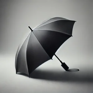 グレーの背景に置かれたシンプルな黒い折りたたみ傘
A simple black compact umbrella placed against a gray background