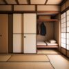 ふすまを開けると布団と衣類が収納された押入れが見える、伝統的な和室 Traditional Japanese room with an open closet (oshiire) showing neatly stored futons and hanging clothes