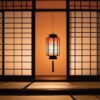 障子の前に灯る行灯がやわらかな光を放つ、静寂に包まれた夜の和室 Traditional Japanese room at night with a softly glowing andon lantern in front of shoji screens