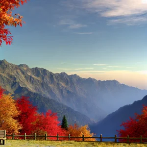 澄んだ空と山の稜線、手前に広がる紅葉が美しい秋の山の風景 A beautiful autumn mountain landscape with a clear sky, rugged ridgeline, and vivid autumn leaves in the foreground